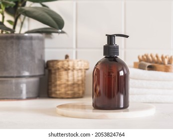 Brown bottle mockup for bathing products in bathroom, spa shampoo, shower gel, liquid soap on marble podium and various accessories front view.