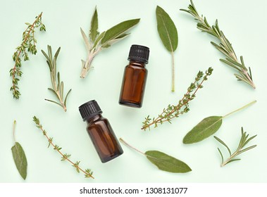 Brown Bottles With Essential Oil And Fresh Herbs, Rosemary, Thyme, Sage, Amber Bottle Mockup Creative Flat Lay.
