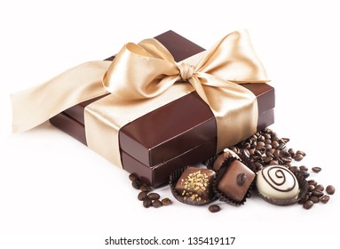 brown box with candies and golden tape, coffee grains - Powered by Shutterstock