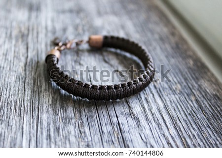 Brown bracelet on the background of wood