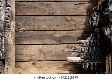 Brown Burnt Wall Of House Of Wooden Planks With Embossed Texture. Background For Copy Space. Damage To The Building From Fire Without The Possibility Of Restoration. Property Insurance.