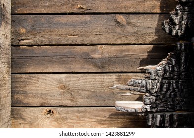 Brown Burnt Wall Of House Of Wooden Planks With Embossed Texture. Background For Copy Space. Damage To The Building From Fire Without The Possibility Of Restoration. Property Insurance.