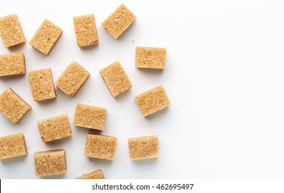 Brown Cane Sugar Cubes On White Background Top View