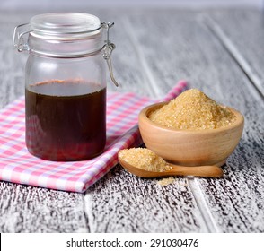 Brown Cane Sugar And Honey On Wooden Board.