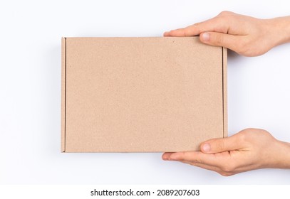 Brown Cardboard Box In Delivery Man Hands, Mockup, On A White Background, Top View 