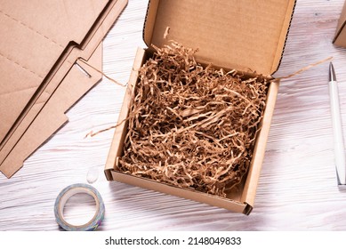 Brown cardboard box on white wooden background 