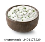 Brown ceramic bowl of fresh sour cream dip sauce with herbs isolated on white background