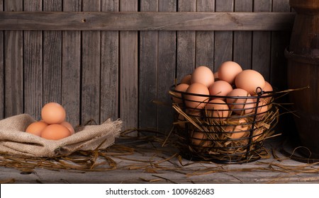 Brown chicken eggs in a basket and on a burlap cloth with copy space