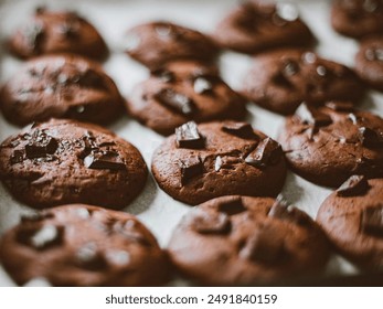 Brown chocolate chip cookies close up view on baking tray, Fresh cookies from oven, Tasty baked cookies. - Powered by Shutterstock