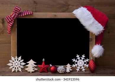 Brown Christmas Blackboard With Copy Space, Free Text As Greeting Card. Red Christmas Decoration, Loop, Santa Hat, Christmas Ball, Christmas Tree, Snowflake. Wooden Background. Vintage Rustic Style. - Powered by Shutterstock