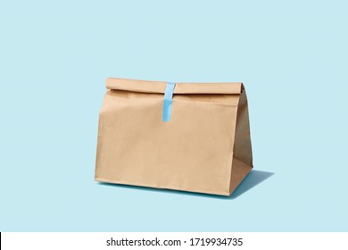 Brown Clear Empty Blank Paper Bag For Food Delivery On Blue Background With Copy Space. Packaging Template Mock Up Fast Food. 