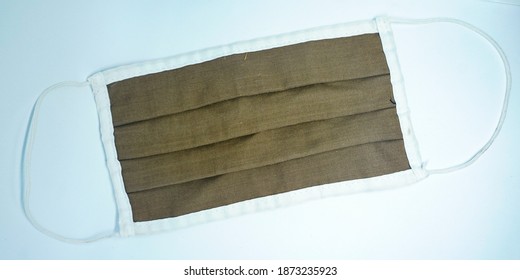 A Brown Cloth Facemask On A White Background