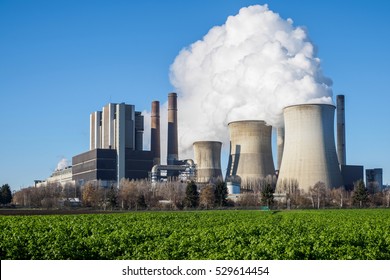 Brown coal fired power plant with green field in foreground. Weisweiler / Eschweiler, Germany