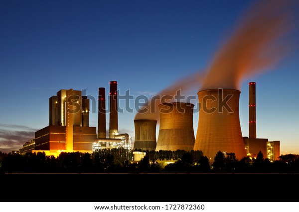Brown\
coal power station with night blue sky and\
steam.