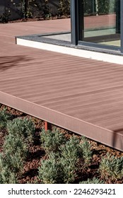 Brown composite deck mounted on the porch of the house - Shutterstock ID 2246293421