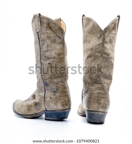 Brown cowboy boots isolated on a white background.