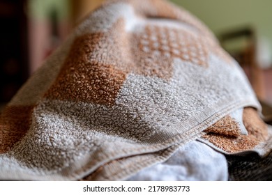 A Brown Crumpled Towel On The Table