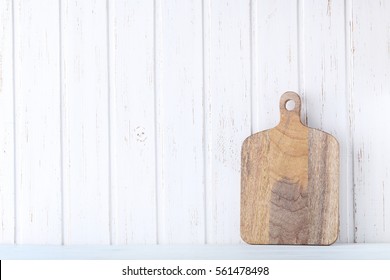 Brown Cutting Board On White Wall Paneling Background