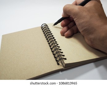 Brown Diary Book And Black Pen On Holding Hand Taking Write On Paper