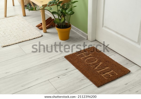 Brown door mat on floor in\
hallway