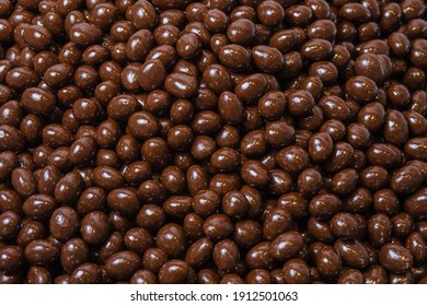 Brown dragee, chocolate covered nuts, background