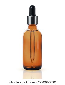 Brown dropper glass bottle of essential oil isolated on white background with clipping path.