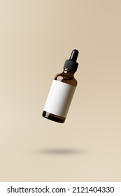Brown dropper glass bottle flying in antigravity on pastel beige background. Levitation object in the air. Skincare concept. Organic natural cosmetic product. Mockup, minimal style - Shutterstock ID 2121404330