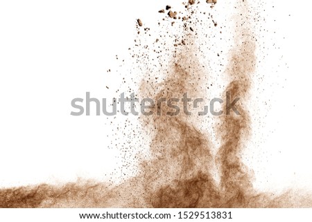 Brown dust explosion cloud.Brown particles splatter on white background.