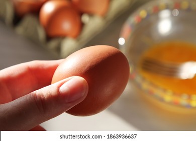 Brown Eggs And Eggshell In Egg Carton In The Kitchen On A Sunny Day.