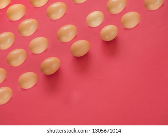 Brown eggs pattern on red background with copy space