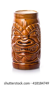 Brown empty tiki mug in the form of scary face on the white background