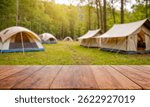 Brown empty wooden table blurred background with camping tents in the background