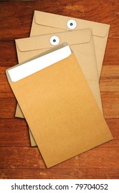 Brown Envelope Document  On A Wooden Desk