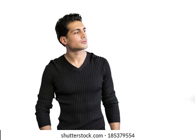 Brown eyed, black haired latin man standing on white background looking to a side