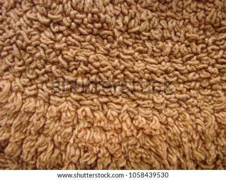 Brown fabric carpet with long pile texture background