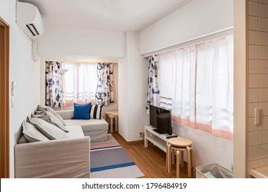 Brown Fabric Sofa And TV In The Living Room In A Small Mansion Suite