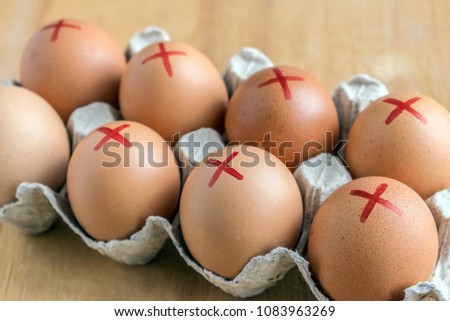 Brown farm eggs with red cross in white carton. Eggs recall over salmonella. How to buy safest eggs after recall