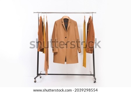 brown fashion brown suit ,long coat ,jacket and scarf,on hanger