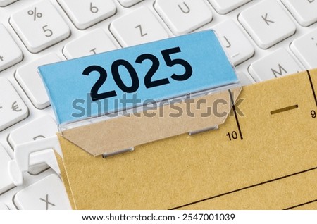 A brown file folder labeled with 2025