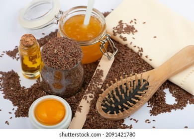 Brown Flax Seeds, Linseeds Oil, Egg, Honey And Hair Brush On White Background. Hair Care Mask.