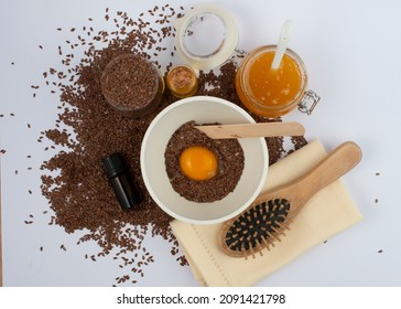 Brown Flax Seeds, Linseeds Oil, Egg, Honey And Hair Brush On White Background. Hair Care Mask.