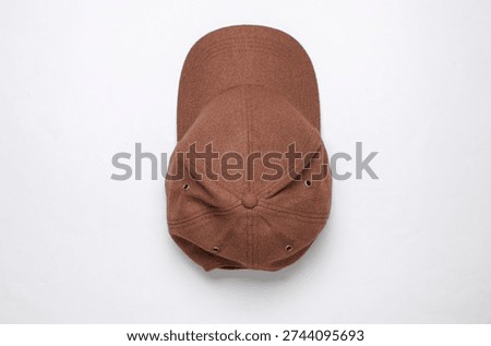 Brown fleecy baseball cap on a white background