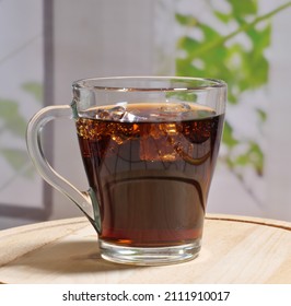 Brown, Frothy Drink, Cola With Ice In A Glass. Close-up. Selective Focus.