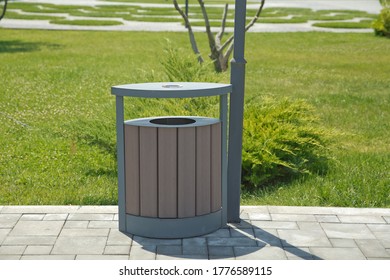 Brown Garbage Bin Inside A Wooden Enclosure At A Park.