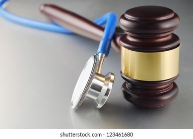 Brown Gavel And A Medical Stethoscope On Gray Background