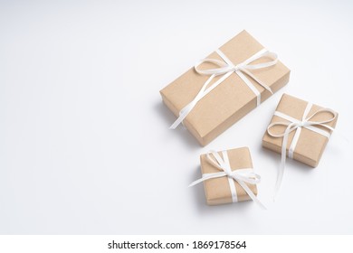 Brown Gift Box Tied With White Ribbon On Clear Background, Copy Space, Eco-friendly Present Concept