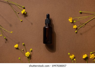Brown glass bottle of cosmetic product or oil on stone and yellow wildflower on beige brown paper background. Natura Spa Cosmetic Beauty concept with hard shadows side view - Shutterstock ID 1997030057