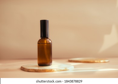 Brown Glass Cosmetic Bottle On Warm Light Pastel Background. Minimalism, Copy Space. Beauty Blogging, Sustainable Brand Packaging Concept