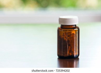 A Brown glass medicine bottle on table with copy space.