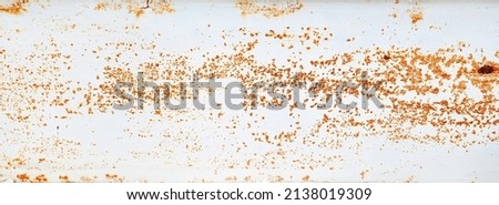 brown grainy rust texture on white metallic background with space for design. panoramic image of a metal wall with cracks, scratches and stained. 
